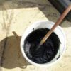 organic indigo hair dye paste ready to use, picture of indigo dye in a small white plastic tub, with a hint of purple sheen on top