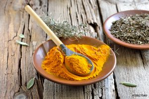 Turmeric henna add in for blondesplate with turmeric powder and wooden spoon