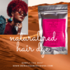 Beautiful woman wearing denim jacket and large statement jewellery and sunglasses, with natural hair dyed red with dermatologist recommended hair colour