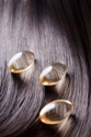 natural hair oils for dry hair improve hair elasticity; vitamin capsules on glossy, health hair