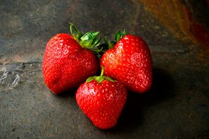 Only a little of the herbal henna mix is needed to get a mild strawberry hair blush; three red strawberries