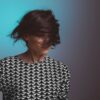 woman shaking her short hair with dark black brown hair dye