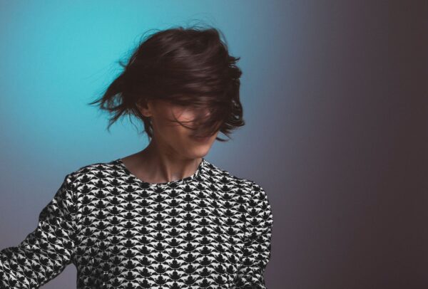 woman shaking her short hair with dark black brown hair dye