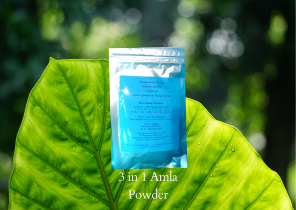 Image of silver foil sealed packet of Renaissance organic Amla powder with blue label against a green leaf background. Amla powder for helathy hair is packed with vitamin C and reputed to make hair grow,