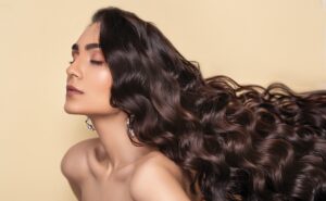 beautiful woman with long silky wavy hair from organic brown hair dye with natural plant based hair dye