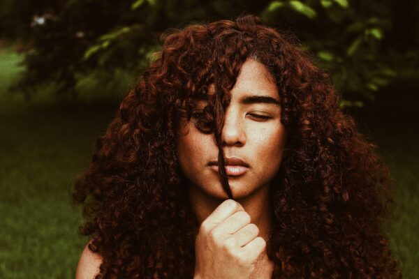 Long curly natural black hair coloured auburn wavy hair