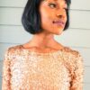herbal hair colouring with henna indigo; beautiful black woman wearing glittery gold dress, sporting short straight bob haircut