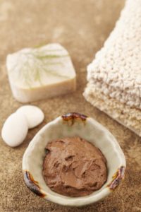 natural shampoo, Moroccan clay in a cream colour pot with bar of natural soap and flannels