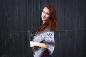 woman with long red hair wearing shawl and natural looking red hair dye