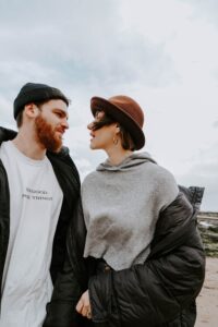 man with dark red dyed beard looking fondly at woman with short natural dark brown dyed hair 