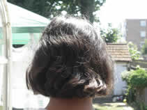 Back of girl's head showing black hair before henna application