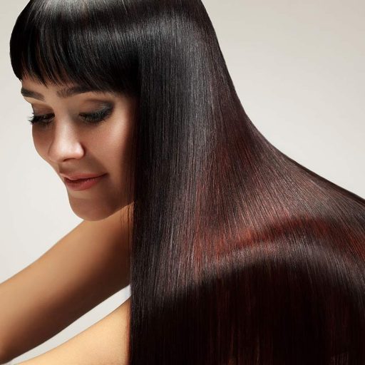 fringed woman with beautiful silky glossy long straight reddish brown hair