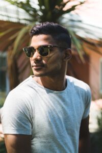 asian man in white T shirt and sun glasses with dark hair colour for men dark brown black