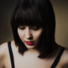 chemical free natural black hair dye on pretty young woman,with short bob hairstyle, looking down
