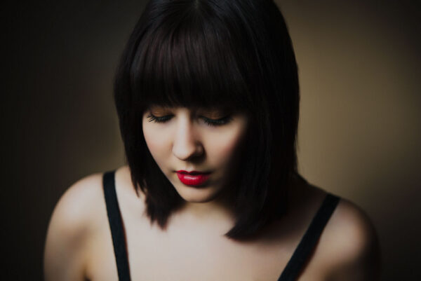 chemical free natural black hair dye on pretty young woman,with short bob hairstyle, looking down