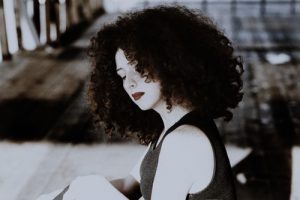 Amla curl and natural hair waves, woman with thick,curly hair, tight curls