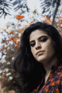 Indigo after henna turns hair chestnut brown to chocolate brown when applied for between approximately 20 to 30 minutes. Photo of woman with long brown hair standing outdoors.