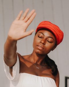 No Chemicals in our Hair Dyes, woman wearing red hat with her hand held up to say NO