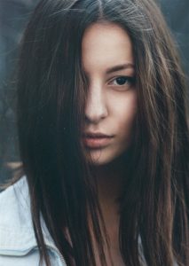 Brown hair, long straight hair, over girl's face