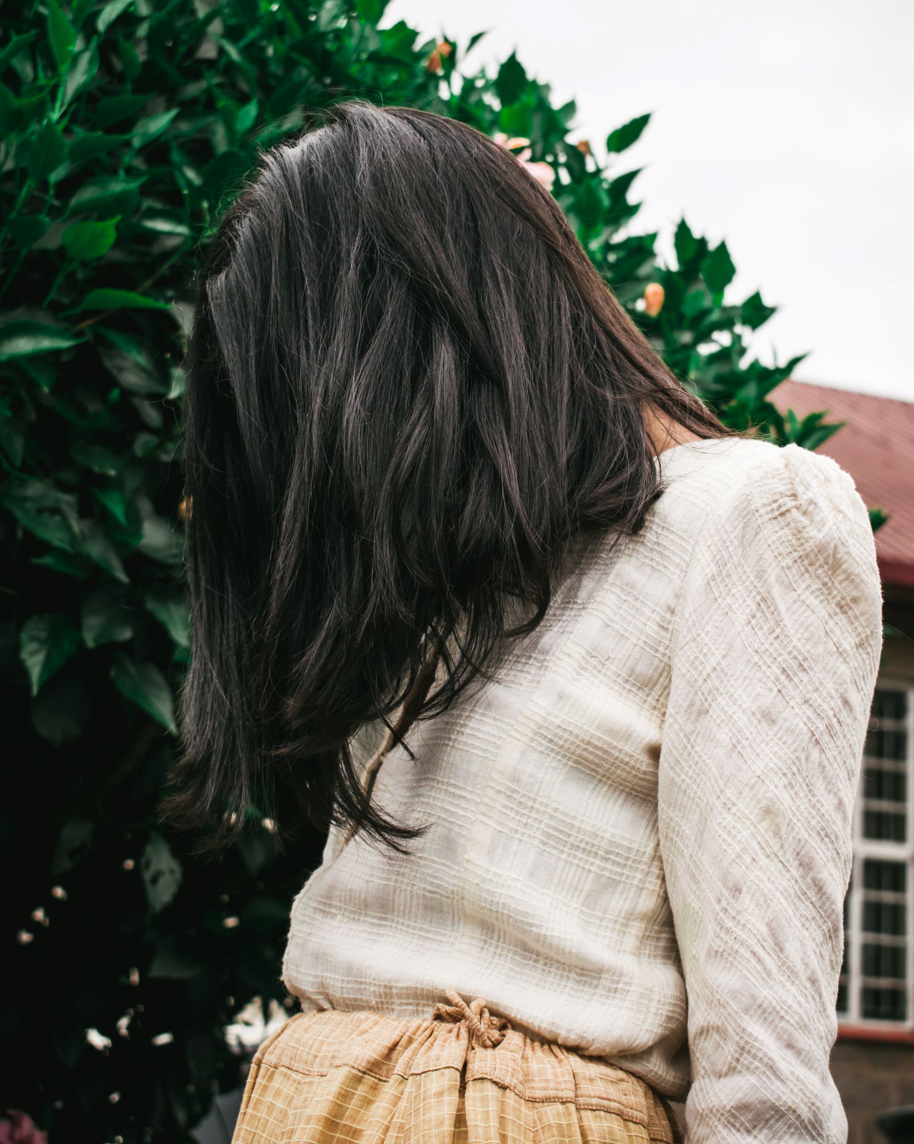 Long brown hair over woman's face