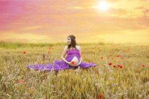pregnancy and hair dyes, picture of pregnant mother sitting in a field of flowers