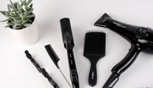 hair salon safety - read on for beauty parlour syndrome - could your salon shampoo put you at risk of a stroke? ; photo of black hair tools on a white counter next to a plant