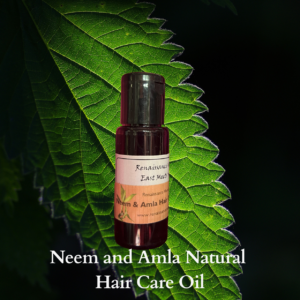 Product image of neem and amla natural hair oil against a leaf background